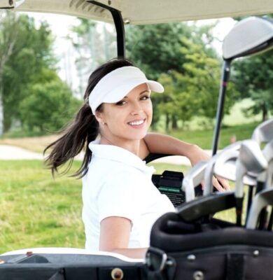 A woman driving a golf cart at the one of the luxurious country clubs in Florida.