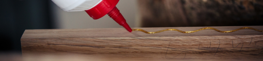 Liquid nails being applied on wood.