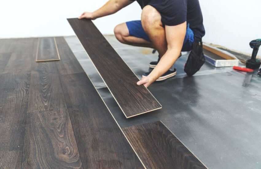 a man installing a basement floor for his project