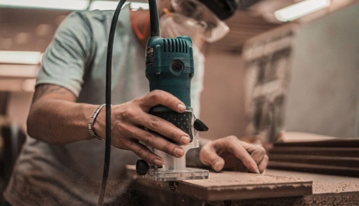A carpenter using woodworking tools.
