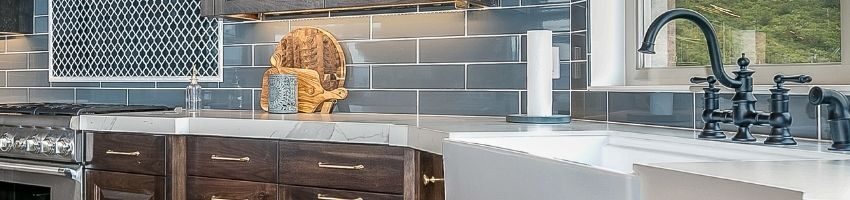 A beautiful farmhouse sink in a blue stone kitchen.