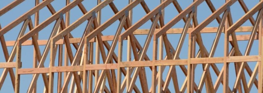 A row of roof trusses on an unfinished house.