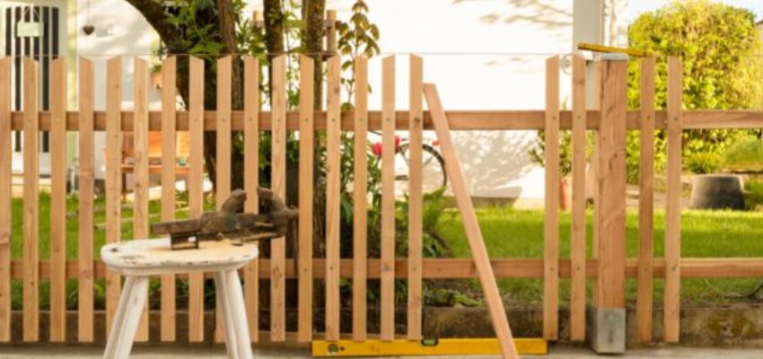 A wooden fence under construction.