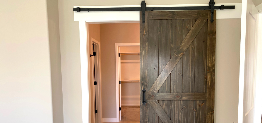 A barn door leading to a walk-in closet.