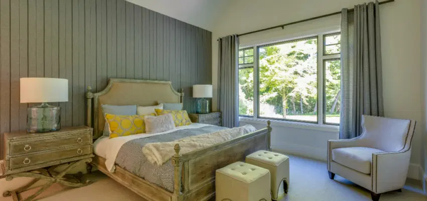 A bedroom with a wood accent wall design.