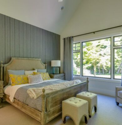 A bedroom with a wood accent wall design.