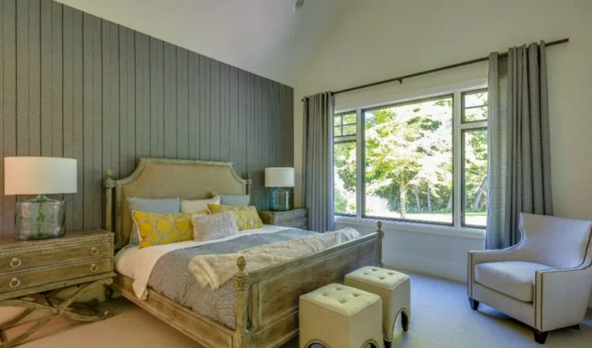 A bedroom with a wood accent wall design.