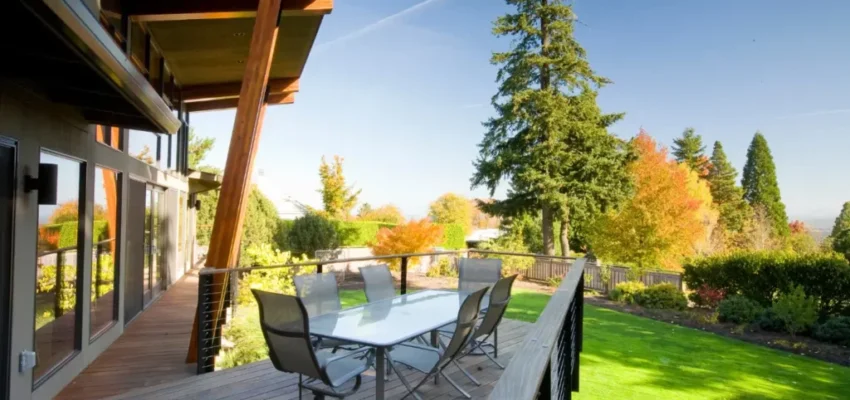 A wooden deck with a table and chairs.