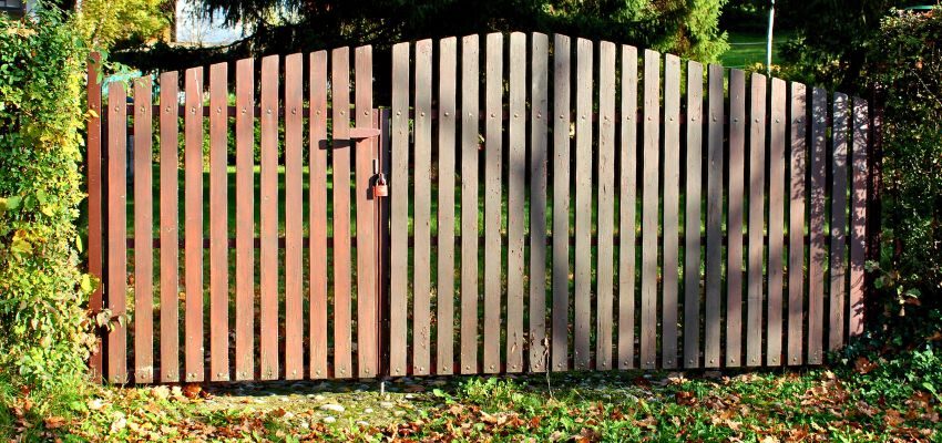 gate ideas wood fence (3) The board-on-board design uses overlapping wooden planks. It creates a strong and highly private barrier.