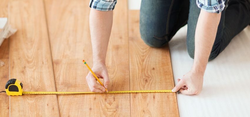 The man is using wide plank wood flooring.