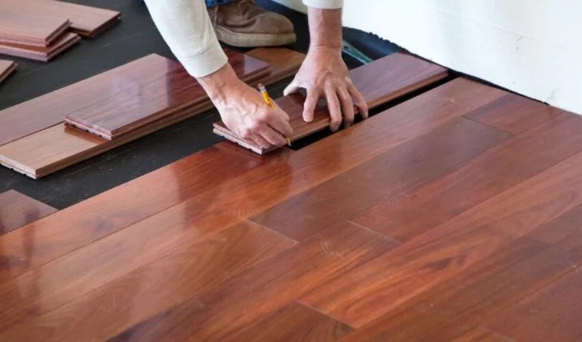 A skilled man is installing a mahogany floor.