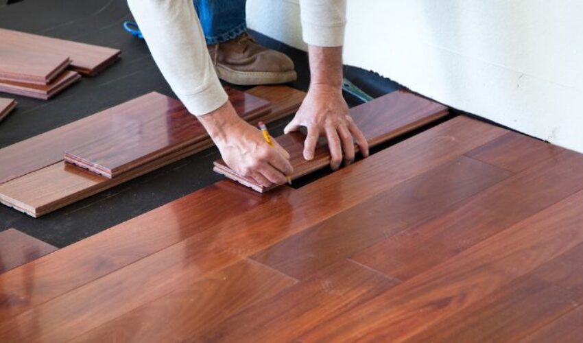 A homeowner installing hardwood on the floors.