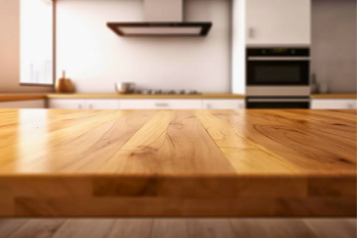 Close-up view of the best wood for countertops with a smooth polished finish in a modern kitchen