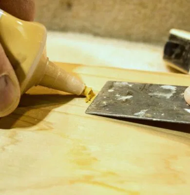 A woodworking enthusiast uses wood putty for minor repairs.