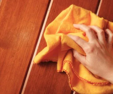 The woman tried to remove the stains from the wood.