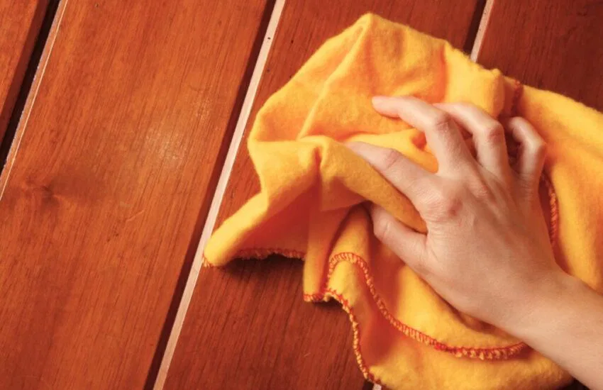 The woman tried to remove the stains from the wood.