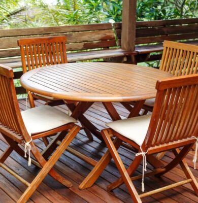 A teak wood furniture was placed outside the house.