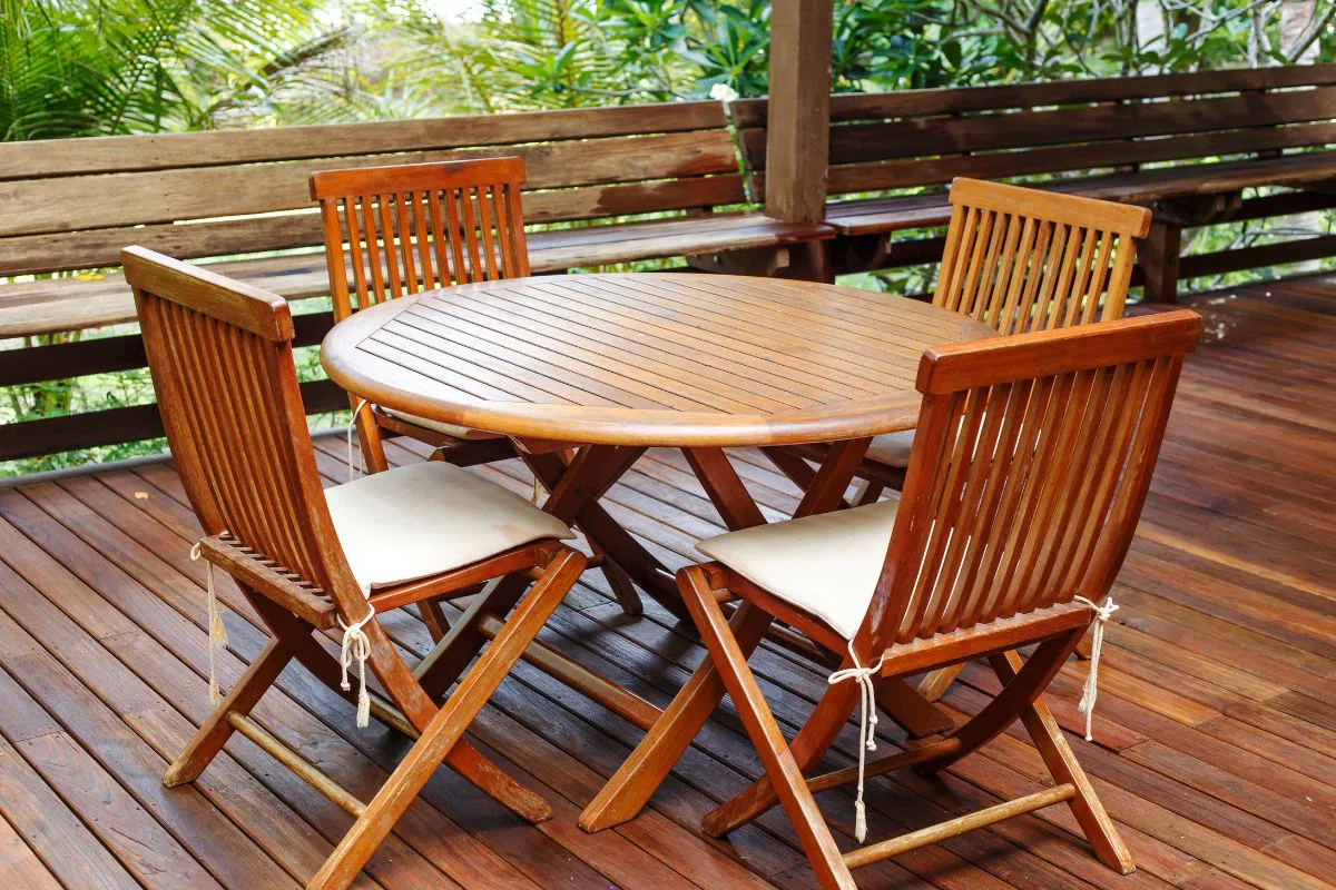 A teak wood furniture was placed outside the house.