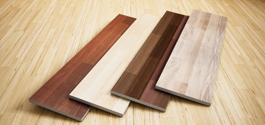 Variety of wood flooring planks in different tones and grains displayed for wood floor identification and comparison.