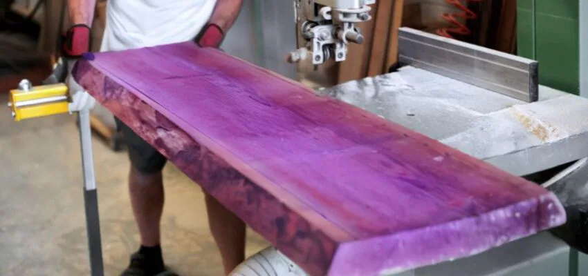 The craftsman uses purple heartwood to make furniture.