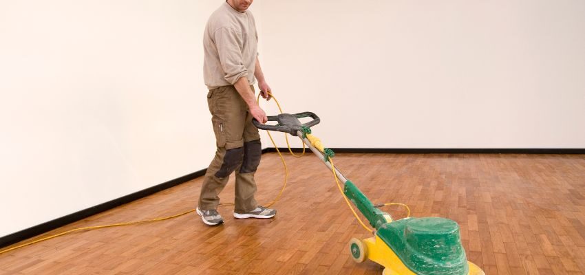 The man is cleaning the floor.