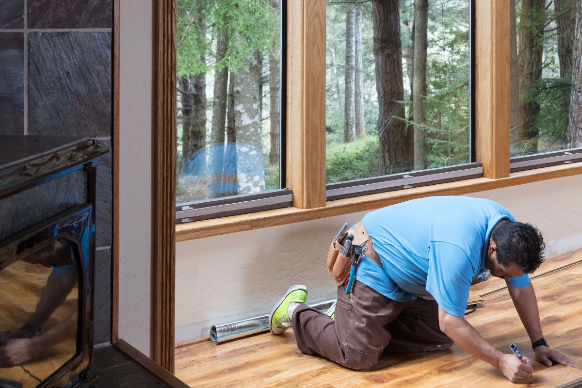 The man is fixing the hardwood floor.