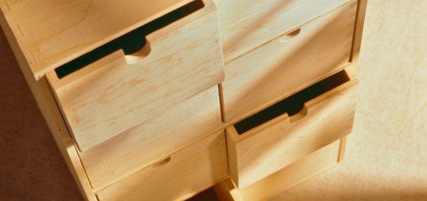 Light wood drawers partially open, ready for tips on how to make wood drawers slide easier.
