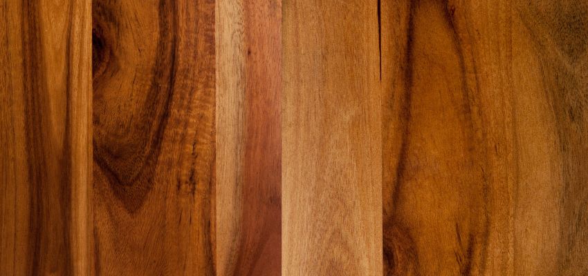 acacia-wood-vs-teak1 Close-up view of Acacia wood planks showcasing varied grain patterns and rich brown tones – Acacia Wood Vs Teak comparison