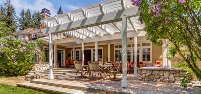 Lush backyard garden space featuring a pergola, demonstrating what a pergola is used for in creating shaded, relaxing retreats.