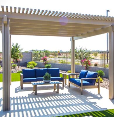 Backyard view showing a wooden pergola with a seating set, illustrating what a pergola is used for.