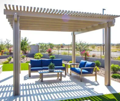 Backyard view showing a wooden pergola with a seating set, illustrating what a pergola is used for.