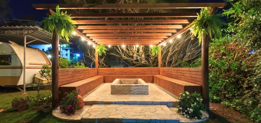 Pergola with a fire pit and seating, visually answering what a pergola is used for in resort-style backyards.