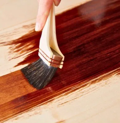 A person restain the wood to preserve and look good again.