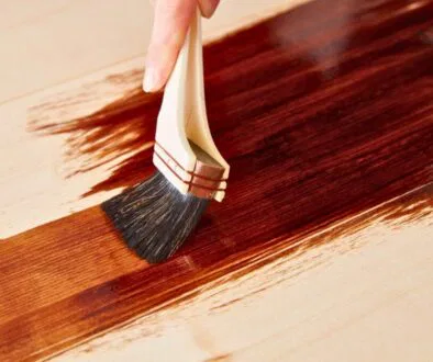 A person restain the wood to preserve and look good again.