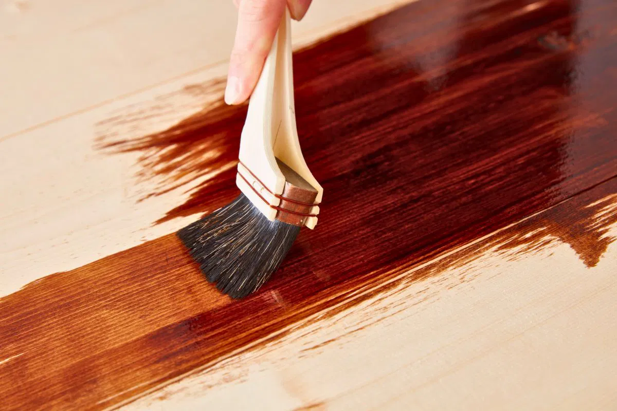 how to restain wood furniture (4) A person restain the wood to preserve and look good again.