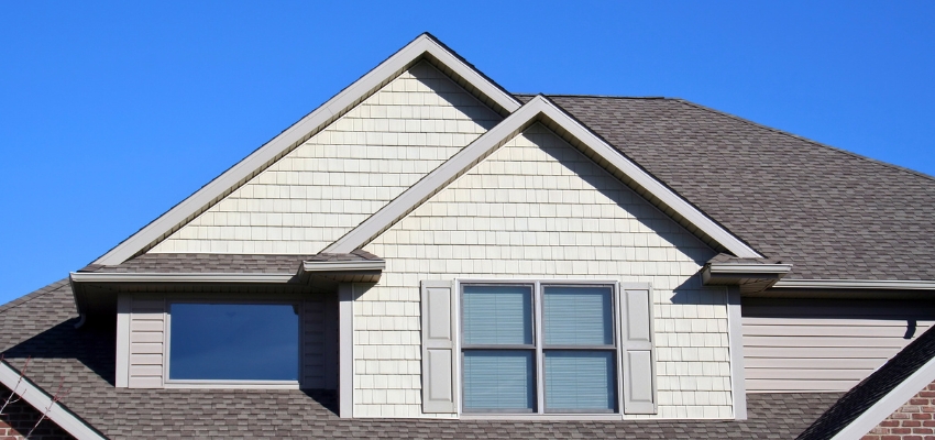 Residential home with multiple gables showing practical application of minimum roof pitch standards.