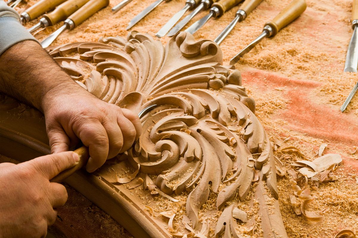 A skilled carver is very detailed in the finishing of his wooden project.
