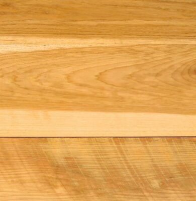 Detailed macro view of smooth, light-toned hickory wood surface showing rich grain patterns, natural knots, and warm golden hues characteristic of premium hickory wood.