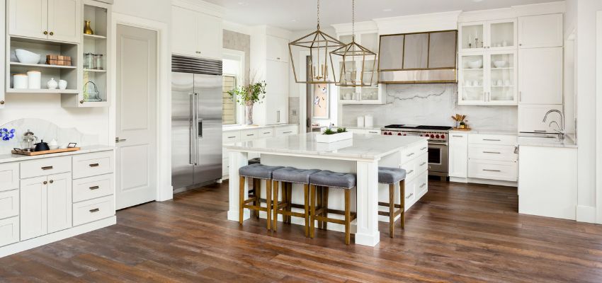 Light cabinet colors like white, cream, or greige brighten spaces.