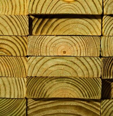 Detailed view of stacked untreated wood showing beautiful growth rings and natural grain patterns.