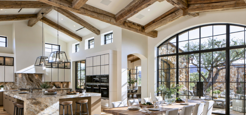 Bright and airy tuscan style kitchen with wooden beams and stunning arched windows
