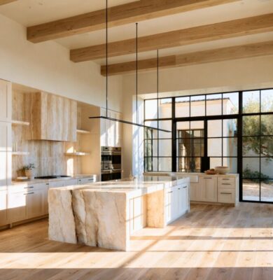 Elegant tuscan style kitchen featuring a large marble island and natural light-filled space