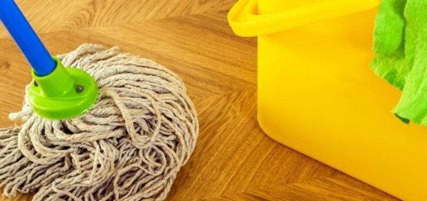 Cleaning a floor with wood floor cleaner.